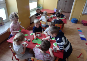 Dzieci wykonują dinozaura z papierowych talerzyków