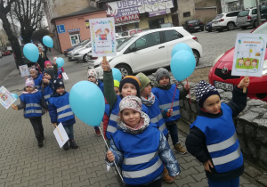 Dzieci maszerują z balonikami i transparentami