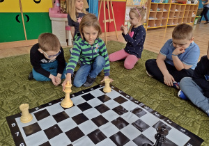 Dziewczyna ustawia figury na szachownicy