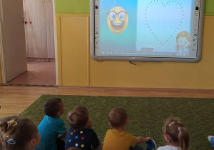 Dzieci oglądają bajkę edukacyjną o kropce
