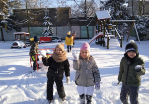 Dzieci lepią kulki ze śniegu