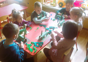 Dzieci wykonują dinozaura z papieru