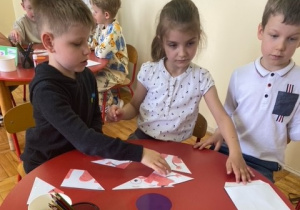 Chłopiec układa obrazek pocięty na części