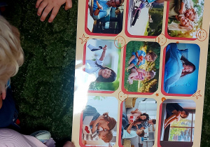 Dzieci oglądają ilustracje na planszy edukacyjnej