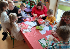 Dzieci i rodzice tworzą kartki Bożonarodzeniowe