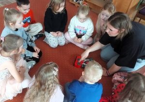 Dzieci oglądają plastikowe narzędzia potrzebne w pracy mechanika samochodowego