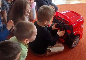 Chłopiec kieruje zabawkowym samochodem