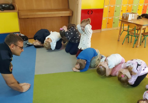 Dzieci ćwiczą pozycję bezpieczną w razie ataku psa