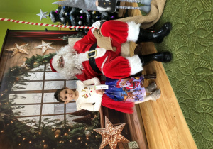 Dziecko pozuje do zdjęcia z Mikołajem