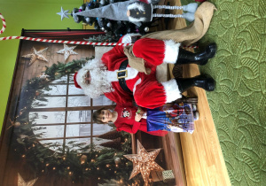 Dziecko pozuje do zdjęcia z Mikołajem