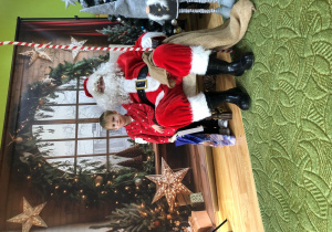 Dziecko pozuje do zdjęcia z Mikołajem