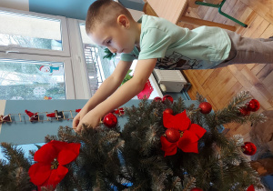 Dziecko ubiera choinkę